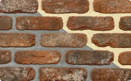 Weathered dark tumbled york brick